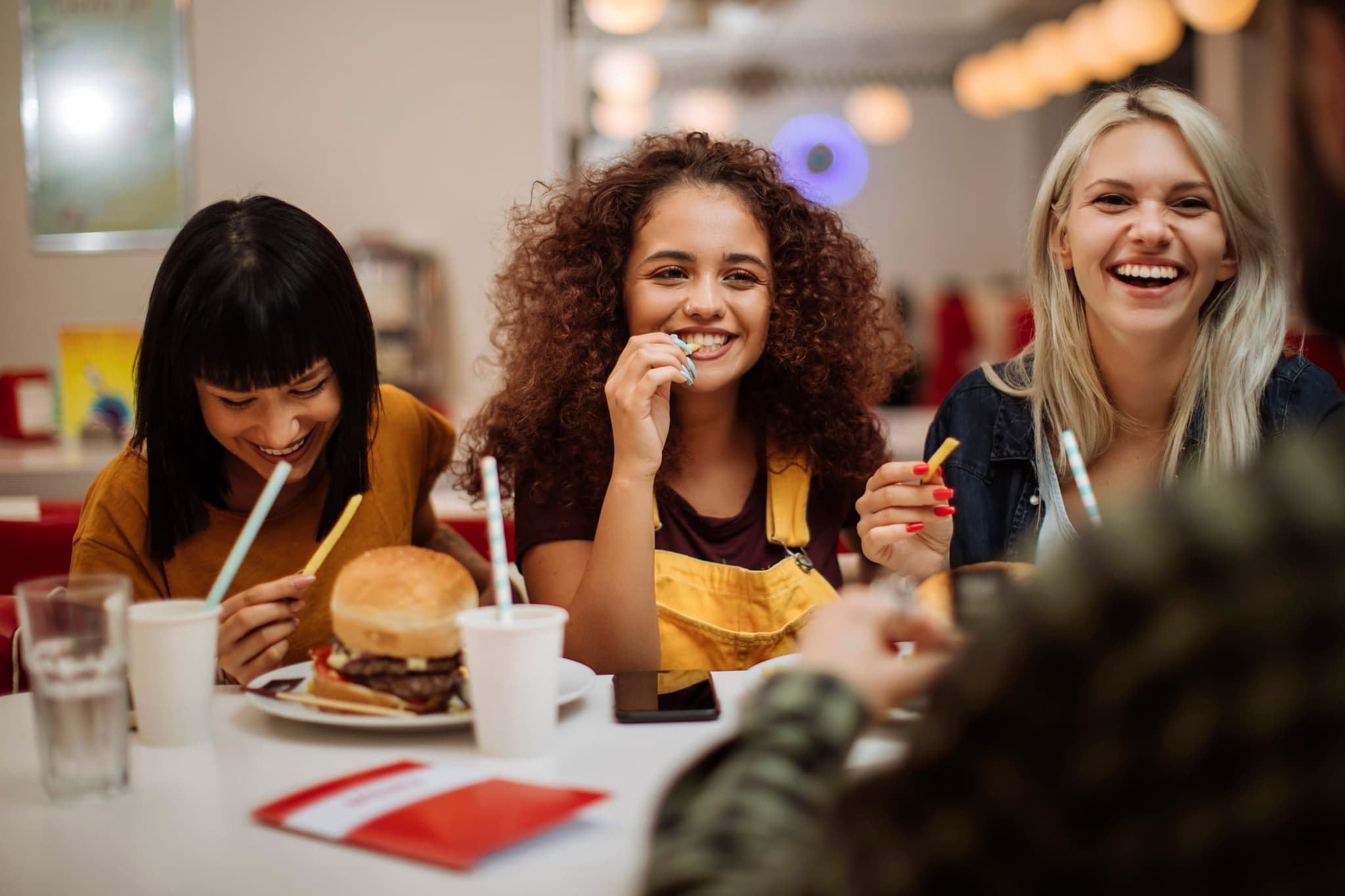 Young people laughing together over dinner