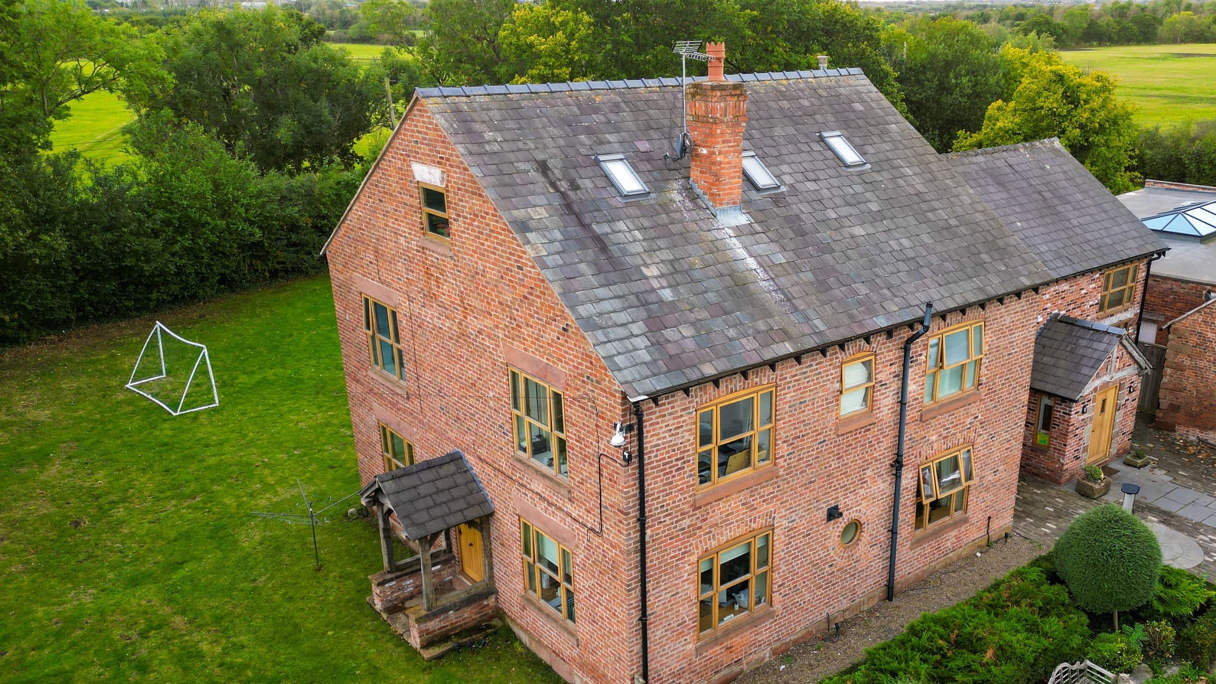 Aerial view of The Farm House, a red-brick children's home in the Knowsley countryside